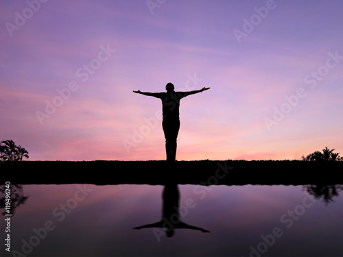silhouette man open arms standing alone on hill
