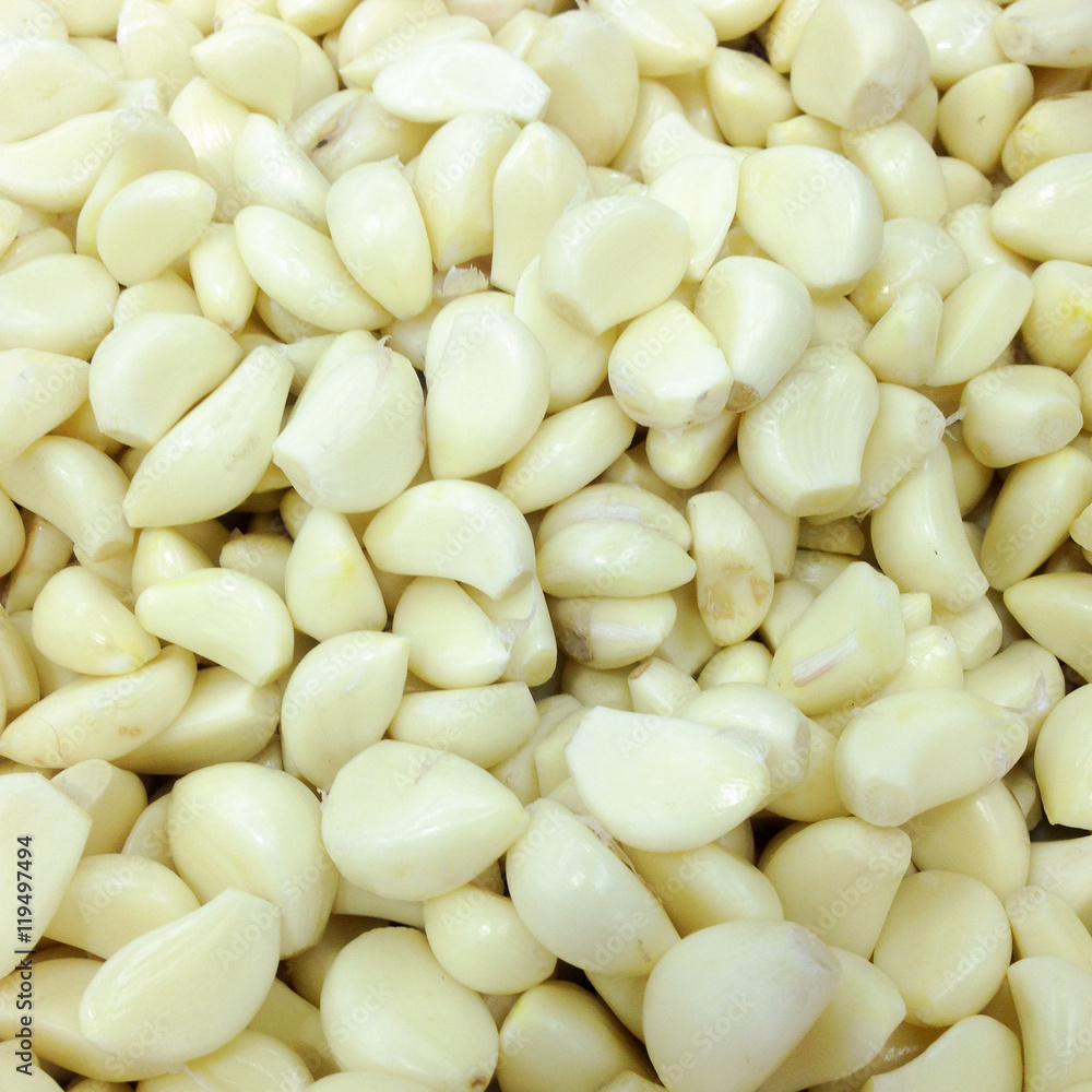 .Closeup of peeled cloves of garlic, background .Closeup of peeled cloves of garlic, background