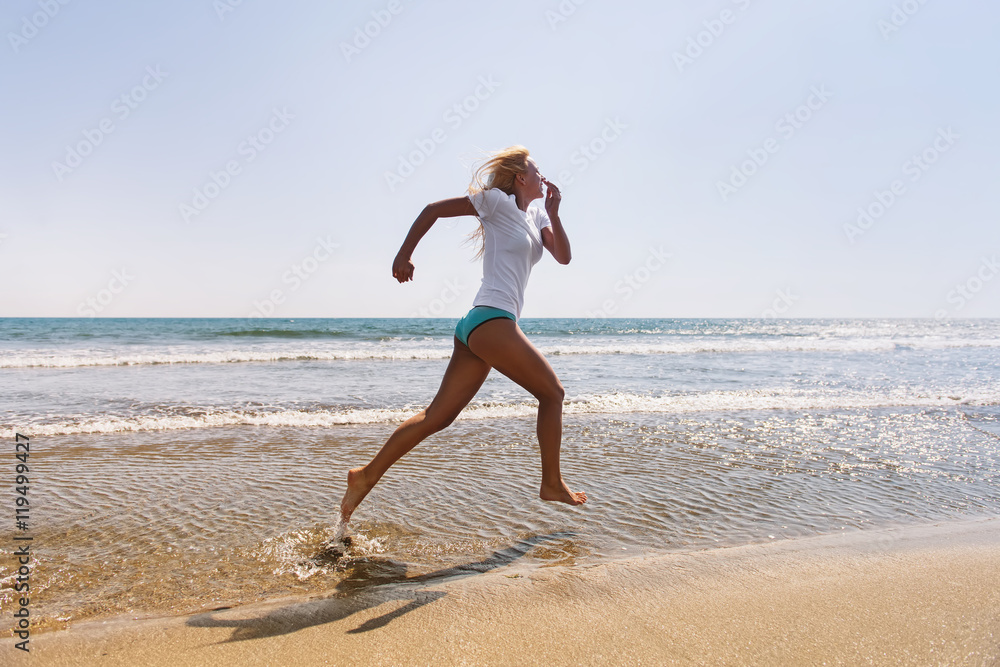 Shot of an attractive young woman running on the beach. Having a fun time at the beach Shot of an attractive young woman running on the beach. Having a fun time at the beach