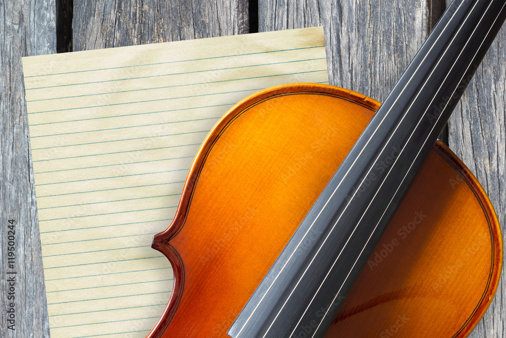 beautiful classical violin, blank paper on old wood background beautiful classical violin, blank paper on old wood background