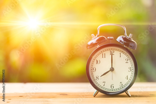 8 o' Clock and Morning sun with Bright and Flare Day Light Blur Green Garden Background with space for text. photo