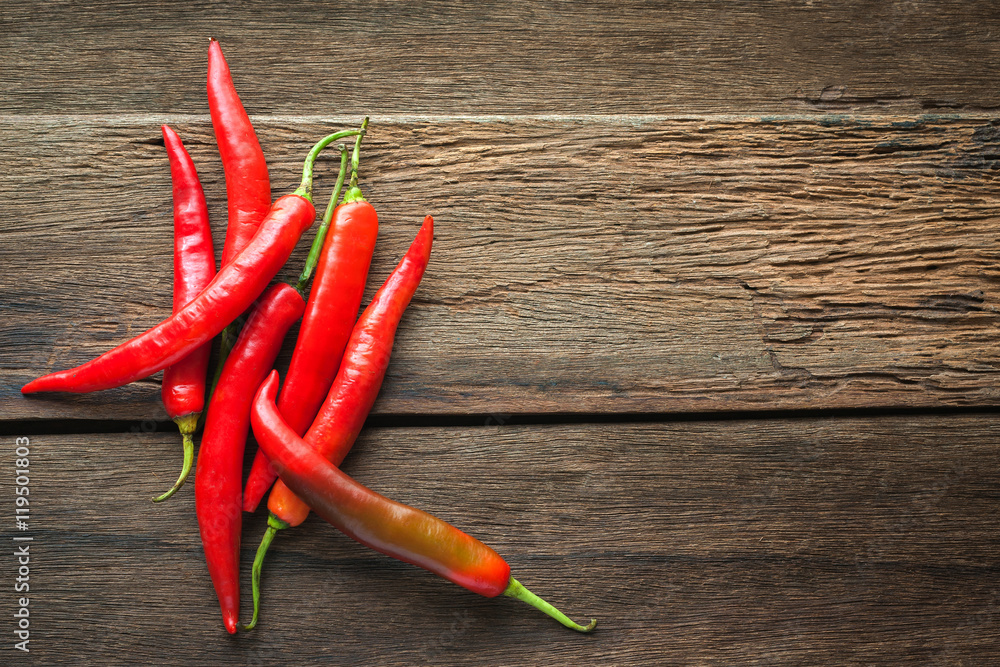red chili peppers on dark wooden background
