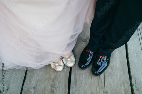 Wedding, brides feet on wooden boards