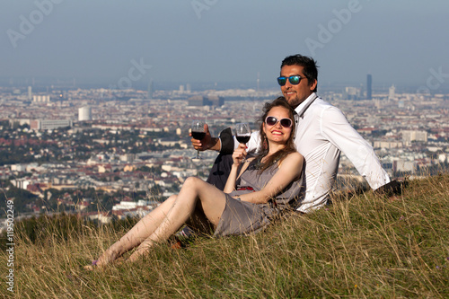 Young multiethnic couple drinking wine in the countryside