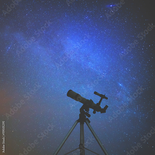 Silhouette of a telescope with starry skies. 