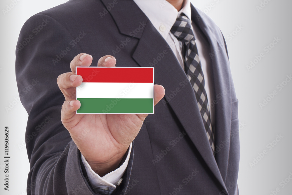 Businessman in suit holding a business card with a Hungary Flag