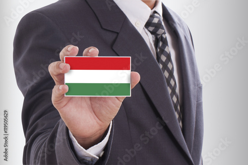 Obraz na płótnie Businessman in suit holding a business card with a Hungary Flag w salonie