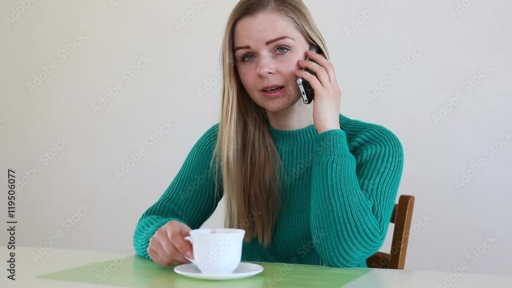 Beautiful blonde woman drinking coffee, talking on the phone Beautiful blonde woman drinking coffee, talking on the phone