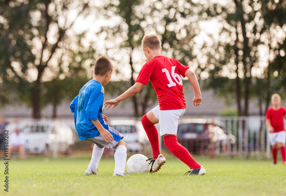 Obraz premium Boys playing football soccer game on sports field
