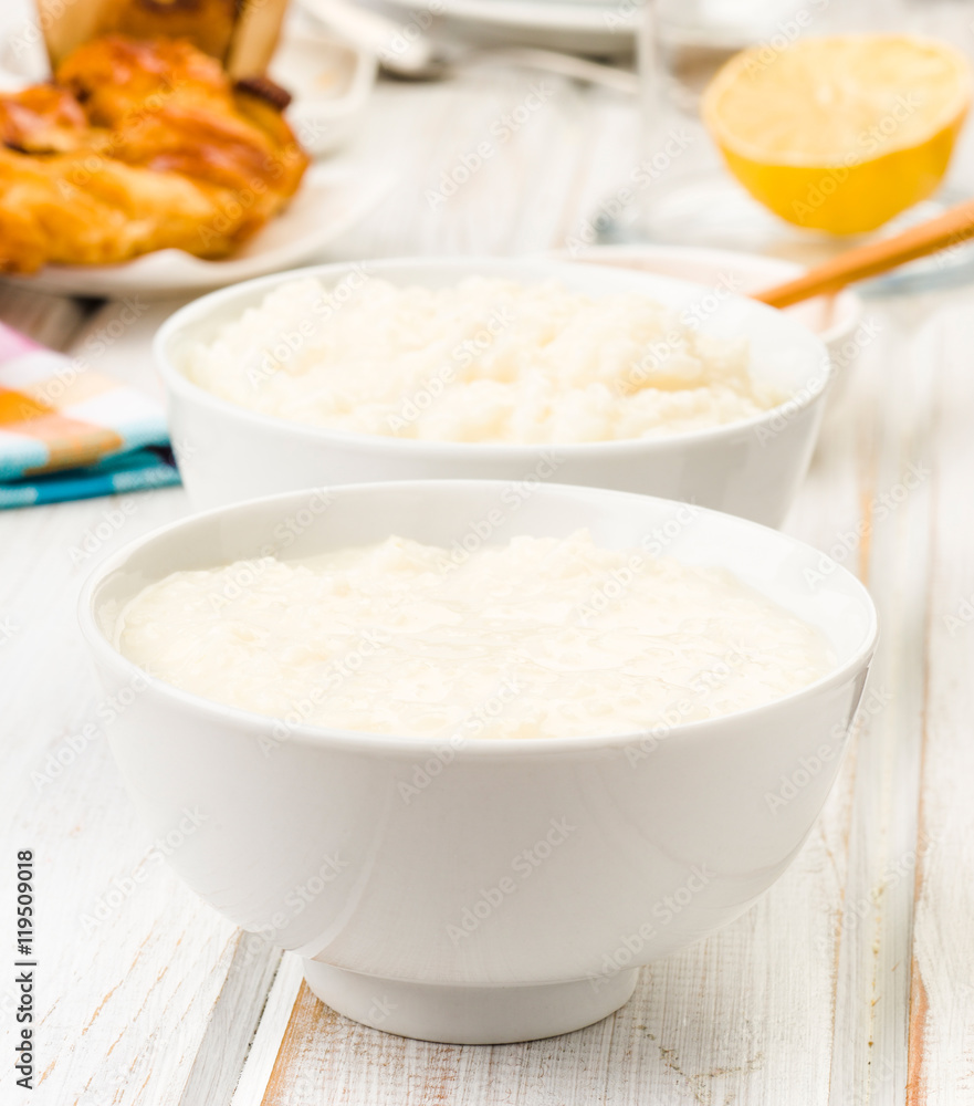 brimming bowls of rice pudding, on wood brimming bowls of rice pudding, on wood