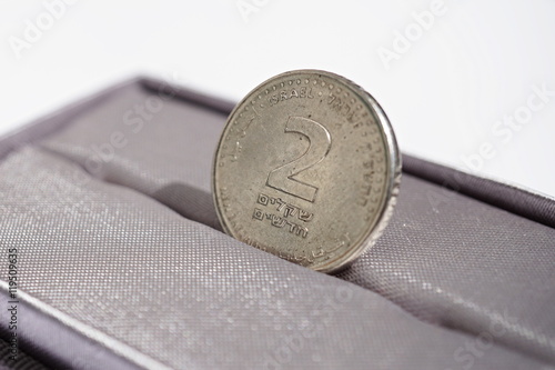 
Macro detail of a metal coin of two Shekels (Israeli currency New Shekel, ILS) placed in the gift box as a symbol of luxury and highly appreciated currency of Israel  photo