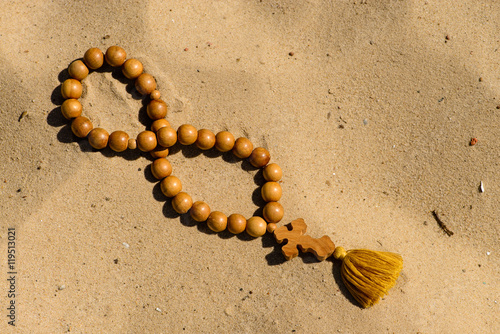 Losing faith rosary on desert religion symbol metaphor