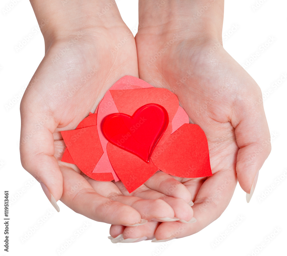 heart above pile of paper hearts on female palms heart above pile of paper hearts on female palms