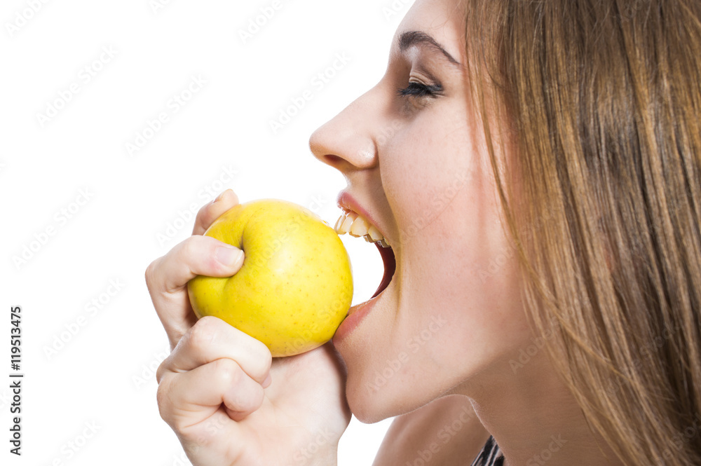 Young girl eating an apple portrait of a close-up isolated on white background. Concept of diet and weight loss. Young girl eating an apple portrait of a close-up isolated on white background. Concept of diet and weight loss.