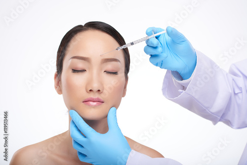 Chinese young woman receiving professional biorevitalization treatment