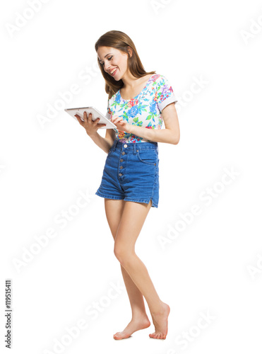 Funny young girl with a tablet isolated on white background.