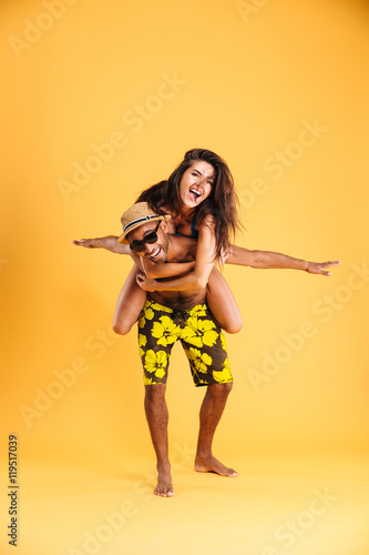 Young happy couple enjoying piggyback ride