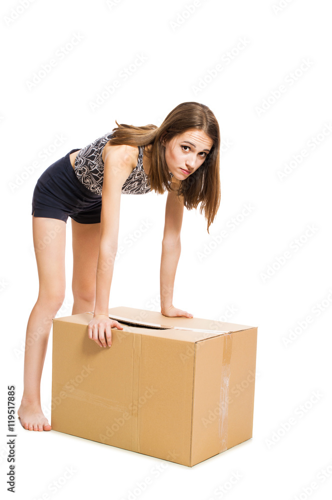 Young pretty girl opens a large box isolated on white background. Young pretty girl opens a large box isolated on white background.