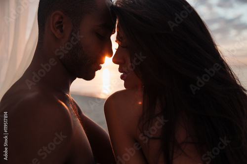 Tender beautiful young couple on sunset