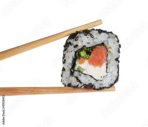 Tasty sushi roll with wooden chopsticks on white background