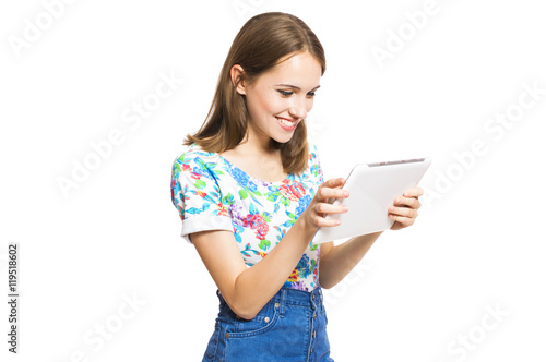 Funny young girl with a tablet isolated on white background.