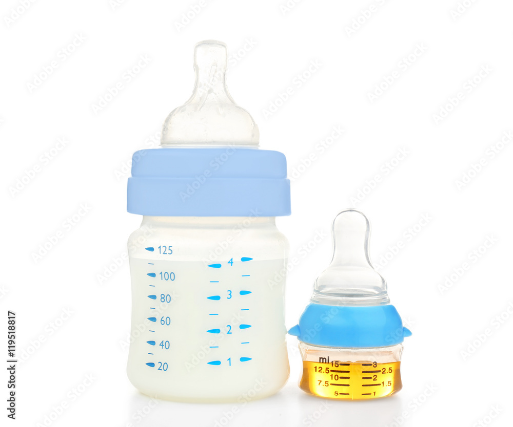 Feeding bottle with baby milk formula and bottle with medicine on white background Feeding bottle with baby milk formula and bottle with medicine on white background