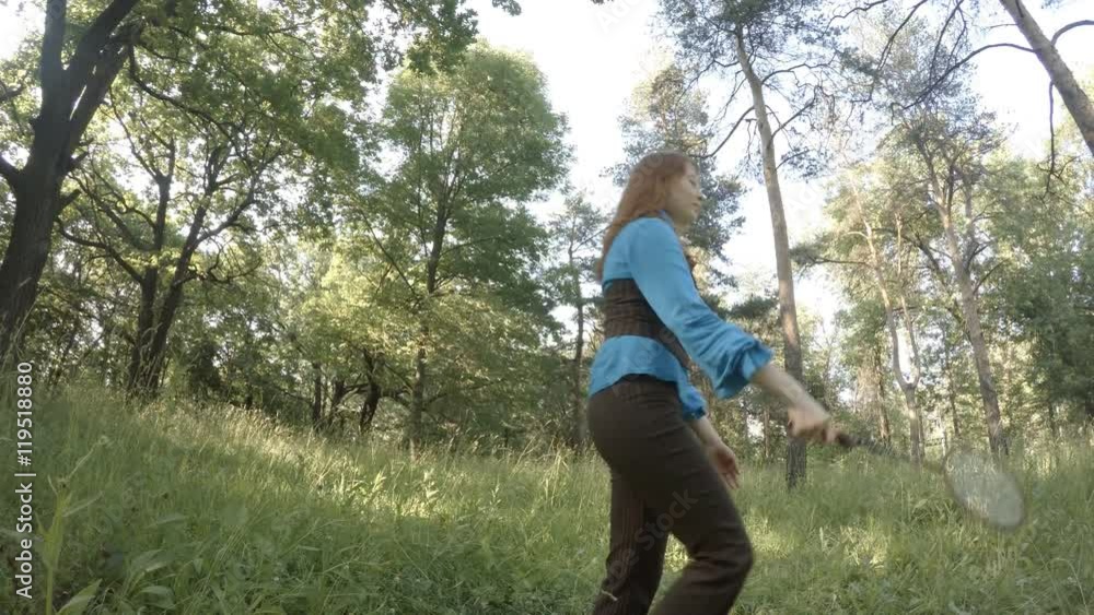 Pretty girl plays badminton on the lawn Pretty girl plays badminton on the lawn
