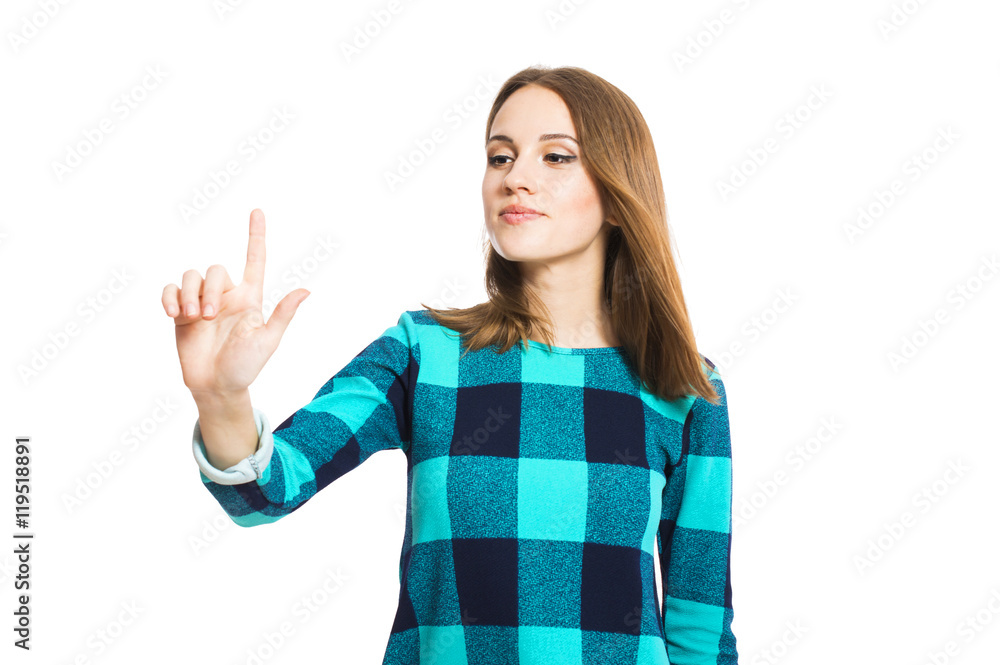 Young cute girl in a checkered dress holding a finger in the air isolated on white background. Young cute girl in a checkered dress holding a finger in the air isolated on white background.