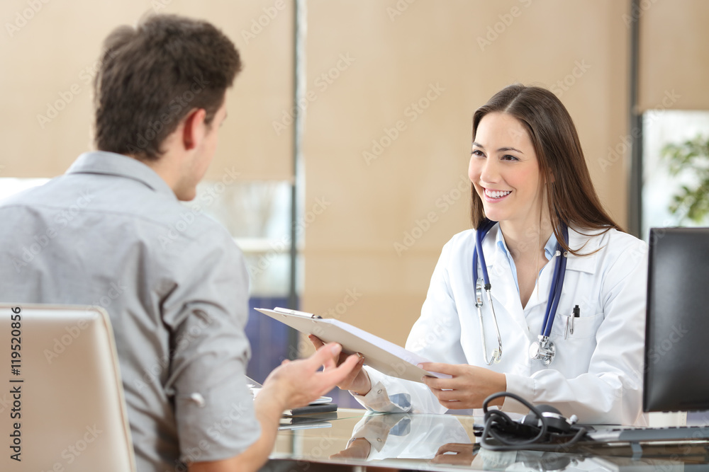 Doctor attending a patient in a consultation Doctor attending a patient in a consultation