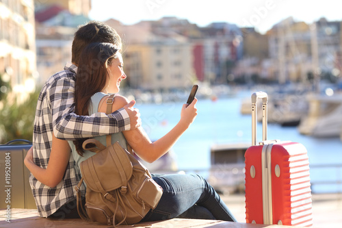 Couple of tourists searching on a smart phone