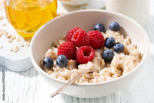 delicious homemade oatmeal with berries for breakfast, closeup