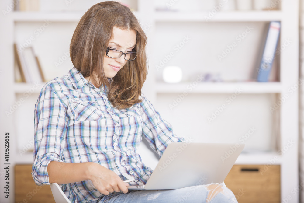 Girl using laptop computer side Girl using laptop computer side