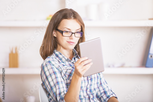 Young woman using digital pad