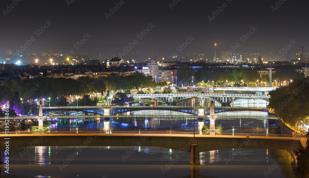 Bridges over the Rhone river in Lyon at a warm, summer night.