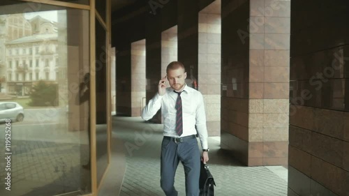 Wallpaper Mural going business man holding brief case over wite in street Torontodigital.ca