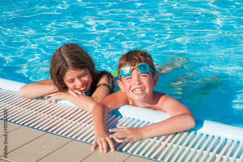Thow children in swimming pool photo