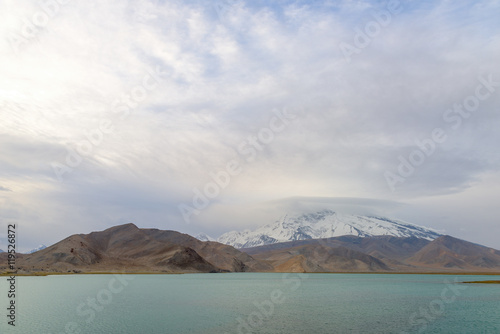 Mount Muztag Ata, the father of ice mountains, and the Karakul Lake, on the Pamirs Plateau, Taxkorgan, Kashgar, Xinjiang, China © Songkhla Studio