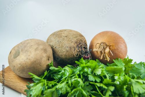 Fresh organic onions  beets  potatoes and parsley isolated - bac