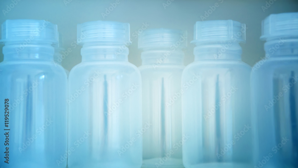 Blur background of empty plastic small bottles in laboratory Blur background of empty plastic small bottles in laboratory