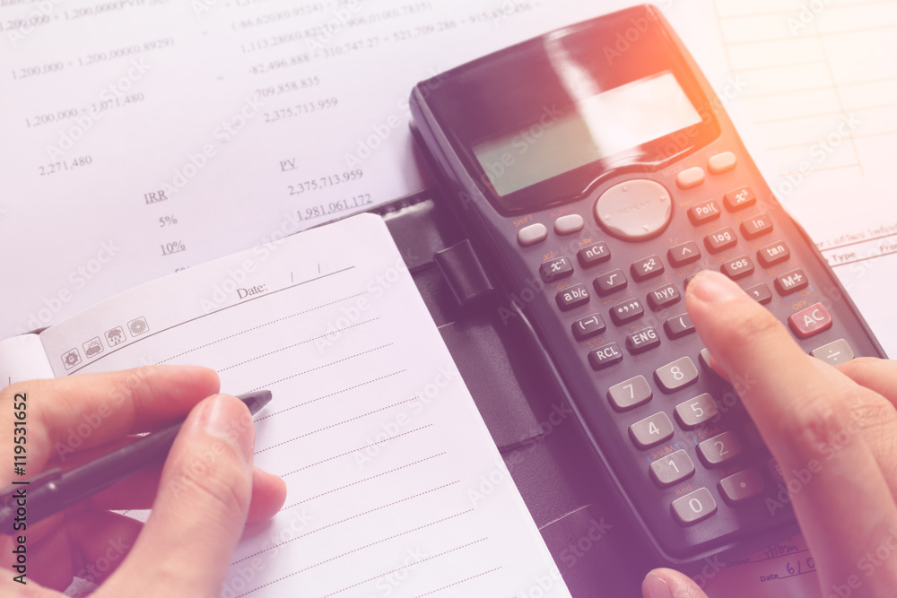 Close-up of Human accountant making calculations while sitting a Close-up of Human accountant making calculations while sitting a