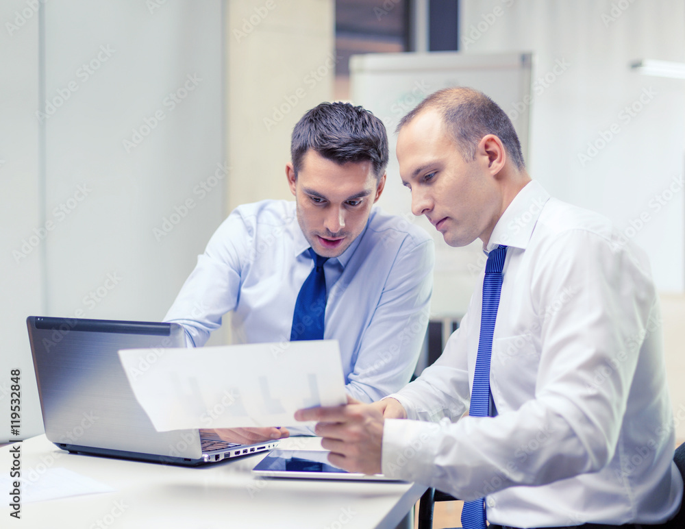 two businessmen having discussion in office two businessmen having discussion in office