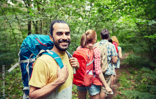 group of smiling friends with backpacks hiking © Syda Productions
