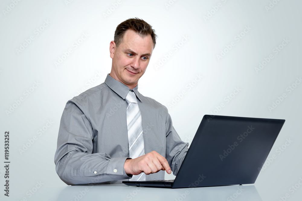 Office man in shirt and tie with laptop on background Office man in shirt and tie with laptop on background