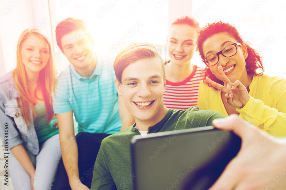 smiling students making picture with tablet pc smiling students making picture with tablet pc