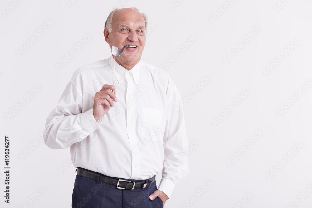 Senior man holding a paper pipe Senior man holding a paper pipe