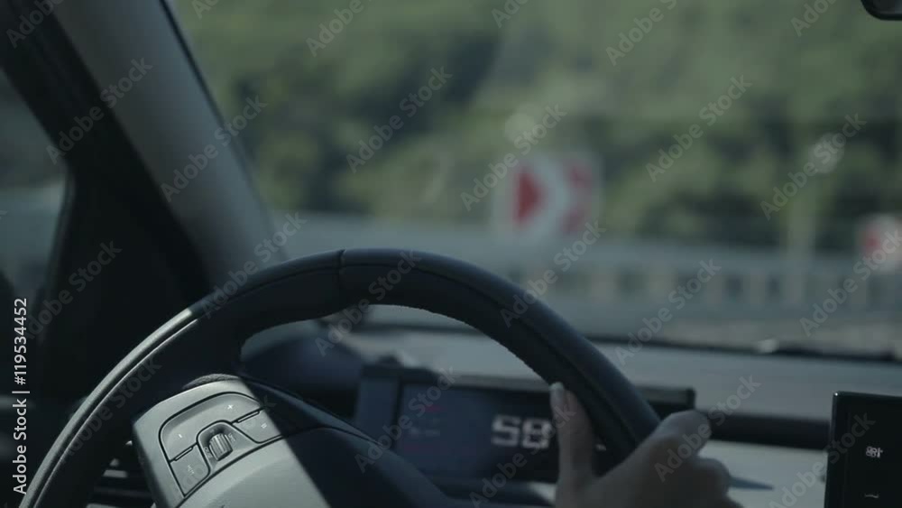 Young woman driving car and making a turn Young woman driving car and making a turn