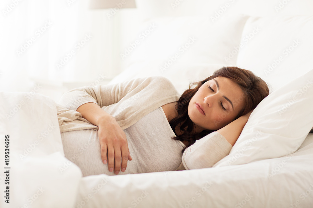 happy pregnant woman sleeping in bed at home happy pregnant woman sleeping in bed at home