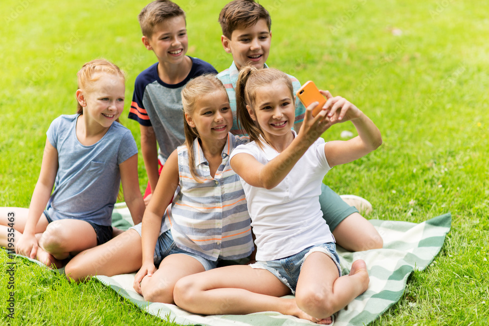 happy kids or friends taking selfie in summer park happy kids or friends taking selfie in summer park