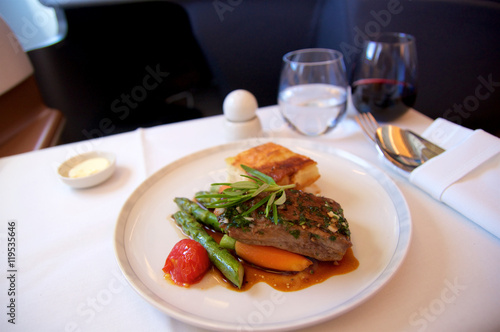 SINGAPORE - JULY 22, 2016: Business Class meal in the Airbus A350 with red wine