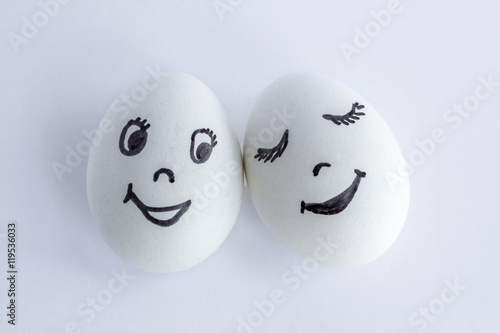 Funny eggs imitating a happy couple of smiling lovers